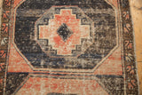 Distressed Oushak runner with faded dusty blush, charcoal, and ivory gul pattern.