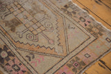 Texture of distressed Oushak pile with even wear, showing apricot, pink, and brown floral motifs.