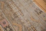 Vintage distressed Oushak runner with faded apricot, brown, and pink pile texture.