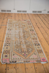 Distressed vintage Oushak runner corner with apricot, blush, and coffee brown primitive floral.