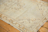 Distressed vintage Oushak runner's worn ivory field and chocolate brown vine border.