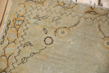 Distressed vintage Oushak rug texture with even wear, vine pattern in ivory, orange, brown.