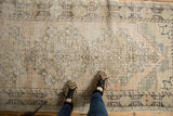 Close-up of distressed vintage Oushak runner's pile, showing even wear to knot heads.