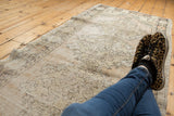 Distressed Oushak rug runner showing soft texture, even wear, and faded floral designs.