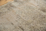 Textured hand-knotted foundation of a distressed vintage Oushak rug, showing painted numbers.