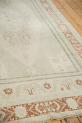 Distressed low pile of the vintage Oushak, featuring soft beige and terra cotta geometric motifs.