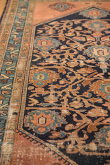 Detail of vintage Persian Malayer rug, worn floral vinery and palmettes in navy, copper, sky blue.