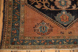 Vintage Malayer rug corner: blush copper field, navy motifs, celadon borders, worn fringe.