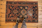 Vintage Lilihan rug with Mina Khani floral trellis design, showing wear, navy, and blush tones.