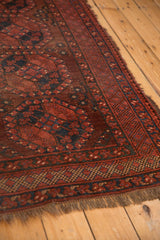 Ersari carpet borders with geometric motifs in wine red, navy, and textured fringe.