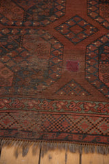 Hand-knotted Ersari carpet detail: geometric gul motifs, decorative border, and surface wear.