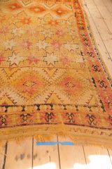 Vintage Moroccan Murat runner: tattered fringe, saffron yellow field, and cochineal red starbursts.