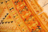 Moroccan Murat runner edge with tatter, hole, and worn saffron yellow pile.