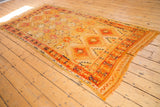 Vintage Murat runner end with tatter and small hole by the orange geometric border.
