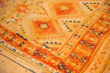 Vintage Moroccan Murat rug detail: saffron yellow, tangerine geometric patterns with visible pile wear.