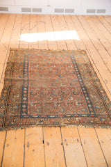 Multi-column floral motif in blush and blue, with tattered fringe on this vintage Hamadan rug.