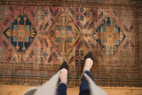 Vintage Malayer rug with raspberry and blue medallions, displaying overall wear to its Herati motif.