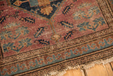Malayer rug's worn Herati motif field, exposed foundation, tattered fringe, and overcast stitch.