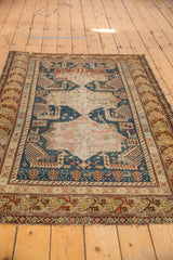 Antique Caucasian Shirvan rug detail: abrashed saffron, rust, indigo geometric borders, field motifs.