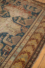 Antique Caucasian Shirvan rug border with rhythmic abrashed indigo and saffron geometric motifs.