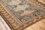 Intricate geometric border details and visible perimeter wear on an antique Shirvan rug.