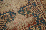Akstafa bird and animal motifs on antique Shirvan rug, featuring hard wear, holes, indigo blue.