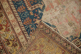 Antique Caucasian Shirvan rug detail: geometric indigo blue pile over extensively worn foundation.