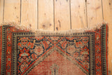 Tattered fringe, reciprocating pawn minor borders, and exposed foundation of a vintage Hamadan rug.