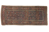 Antique Kurdish Bijar runner presents an allover floral design in navy, madder red, and varied tones, with mostly even wear.