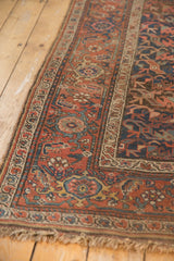 Antique Kurdish Bijar runner end showing madder root red floral field, borders, and frayed fringe.