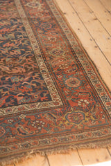 Antique Kurdish Bijar runner's red floral border and navy field, with honest wear.