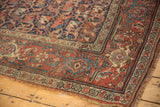 Antique Kurdish Bijar runner corner, madder red border, navy floral field, tattered edge.