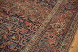 Antique Kurdish Bijar rug's interconnected madder red and navy floral patterns with overall wear.