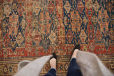 Hand-woven Antique Soumac rug, cherry red, navy, apricot geometric field, visible foundation.