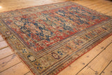Antique Caucasian Soumac carpet's intricate geometric borders, cherry red field, and visible foundation wear.