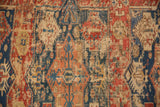 Antique Soumac carpet detail: exposed foundation, geometric patterns, and time-softened red, navy, ivory.
