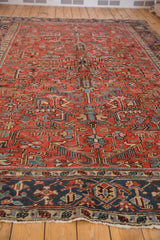 Vintage Heriz rug's navy border with geometric floral motifs and white fringe.