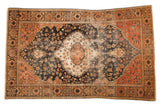 Antique Farahan Sarouk rug with scalloped medallion, floral field in dark blue, ivory, rose.