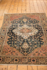 Antique Farahan Sarouk rug featuring scalloped medallion, floral field, low pile, and faint tinting.