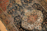 Antique Farahan Sarouk's scalloped medallion, faded floral field, blush, blue, and foundation wear.
