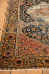 Classic Farahan Sarouk border detail with scrolling florals in dark blue, blush, and ivory.
