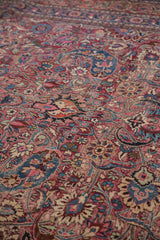 Vintage Meshed carpet's ornate scrolling floral and boteh design in cochineal red and navy.