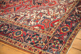 Vintage Heriz hand-knotted carpet with navy Samovar border and ivory geometric patterns.