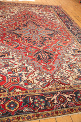 Close-up of vintage Heriz rug's navy Samovar border with cherry red and pale gold repeating motifs.