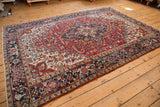 Main border of the vintage Heriz carpet displays reciprocating samovar turtle motif.