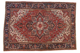 Vintage Heriz carpet, cherry red field, bold quatrefoil medallion and geometric floral patterns.