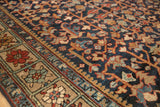 Vintage Heriz carpet detail: Navy field with golden vinery and unique square floral border motifs.