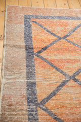 Detail of distressed Oushak rug runner: worn orange pile, dark blue geometric pattern, intact selvage.