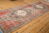 Narrow banded border with distressed cherry red field and charcoal geometric motifs.