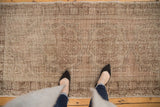 Distressed Oushak runner featuring faded medallions and soft beige, copper tones.